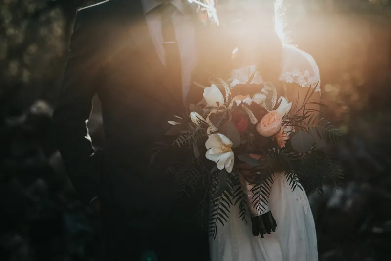 Wedding planning binder open to a vendor budget worksheet