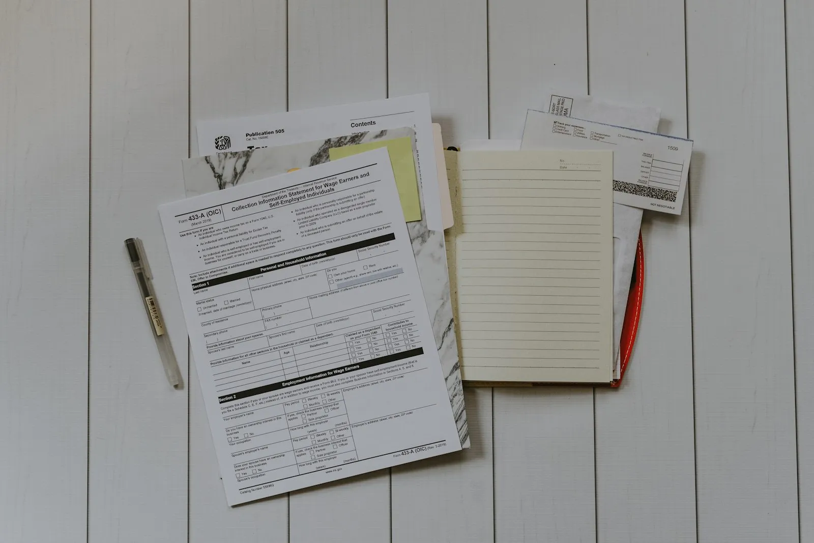 Google Sheets budget configured in zero-based mode next to a notebook