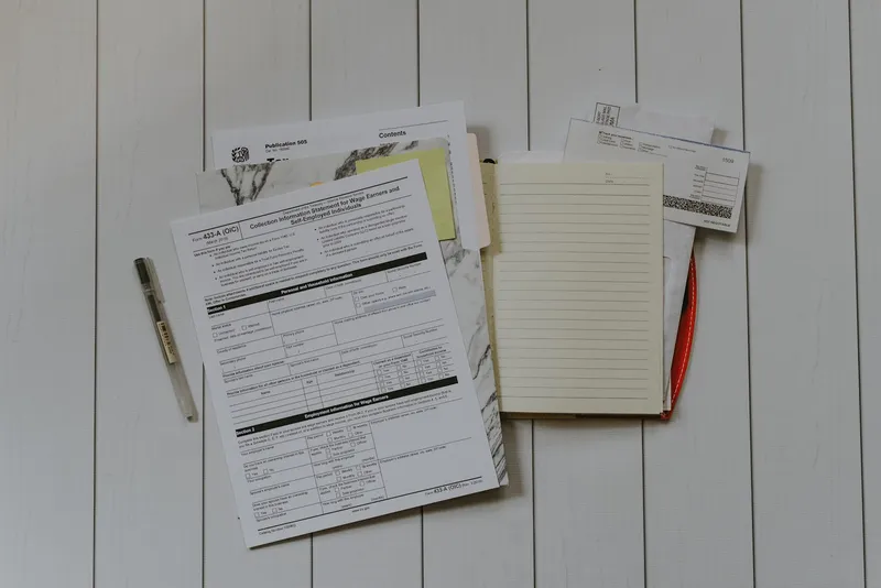 Google Sheets budget configured in zero-based mode next to a notebook